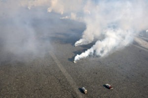 teargas bombs going off in the street