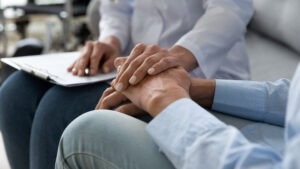 therapist holding patient’s hand