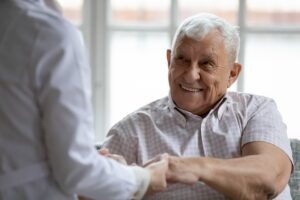 old burn victim shaking hands with doctor